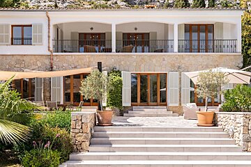 A large house with stairs leading up to it