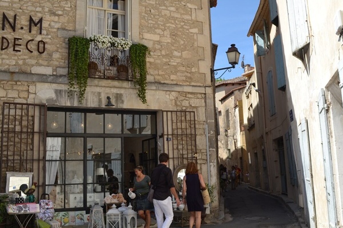 image of the outside of a shop front in a stone building a display sits outside, with an alleyway down to the right