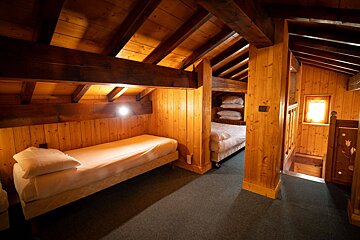 A bedroom with a bunk bed and a single bed