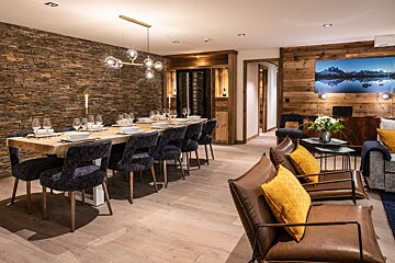 A dining room with a long table and chairs