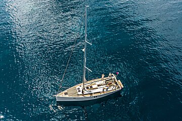 An aerial view of a sailboat in the ocean