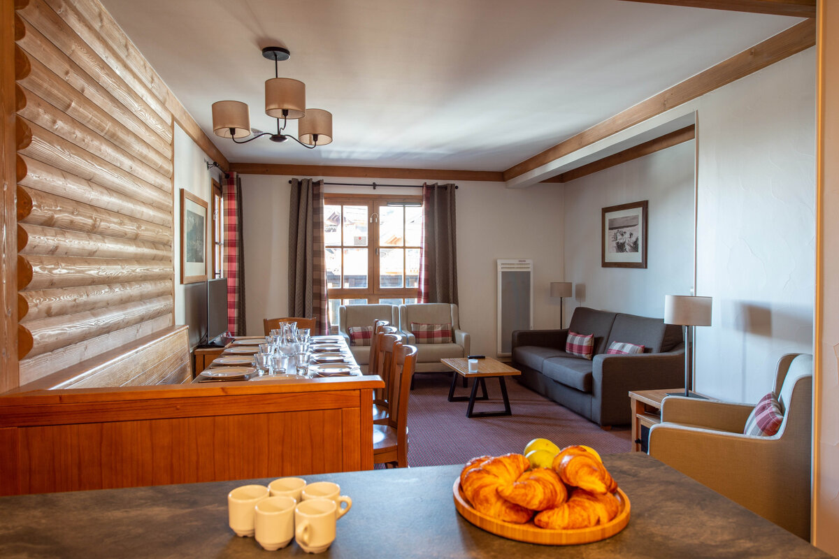 A bowl of croissants sits on a counter in a living room