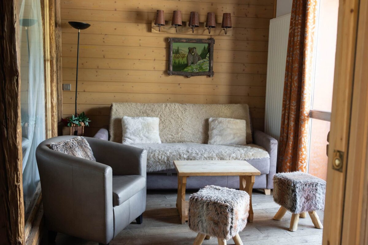 A living room with a couch and two chairs