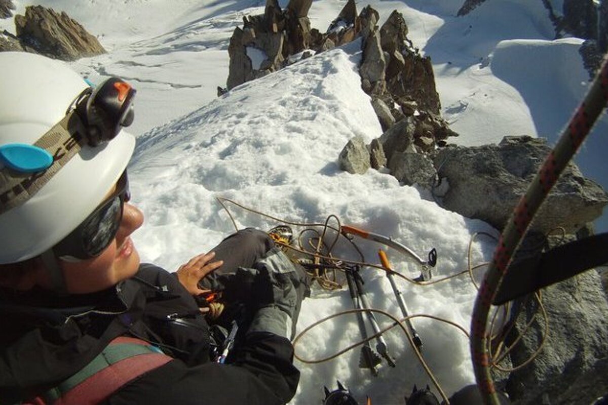 a woman at the top of a climb in Chamonix