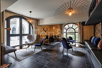 A photo of a living room with the word ten8 on the bottom