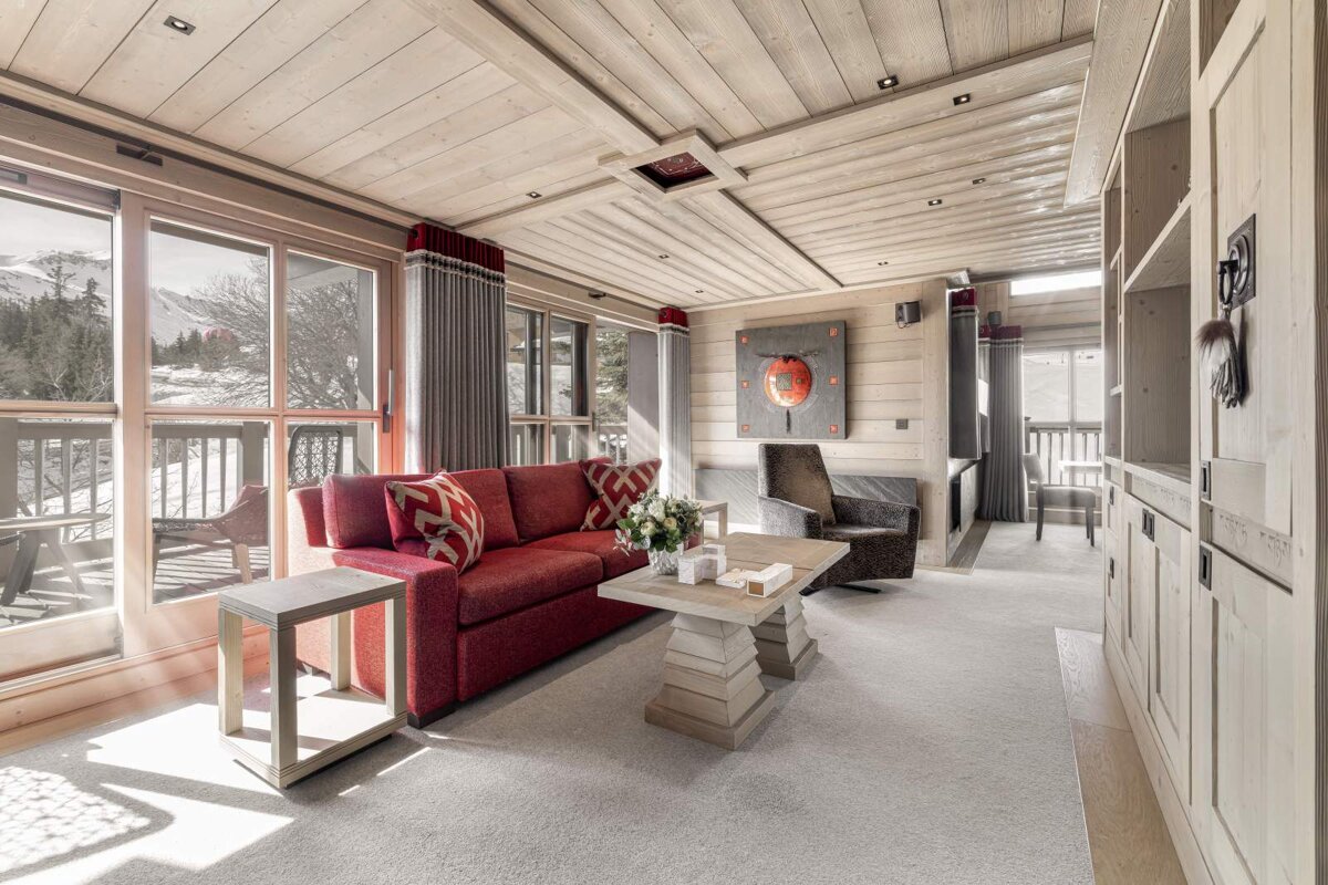 A living room with a red couch and a white coffee table