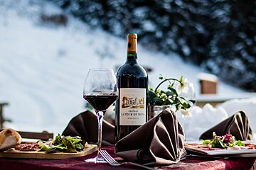 A bottle of la tour de mons wine sits on a table
