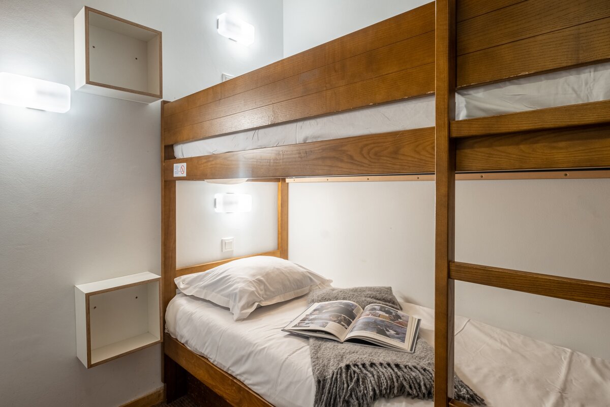 A bunk bed with a book on top of it