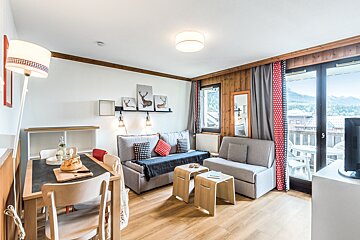 A living room with a couch and two chairs