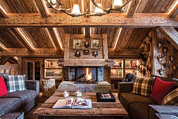 A living room with a fireplace and a book on the table