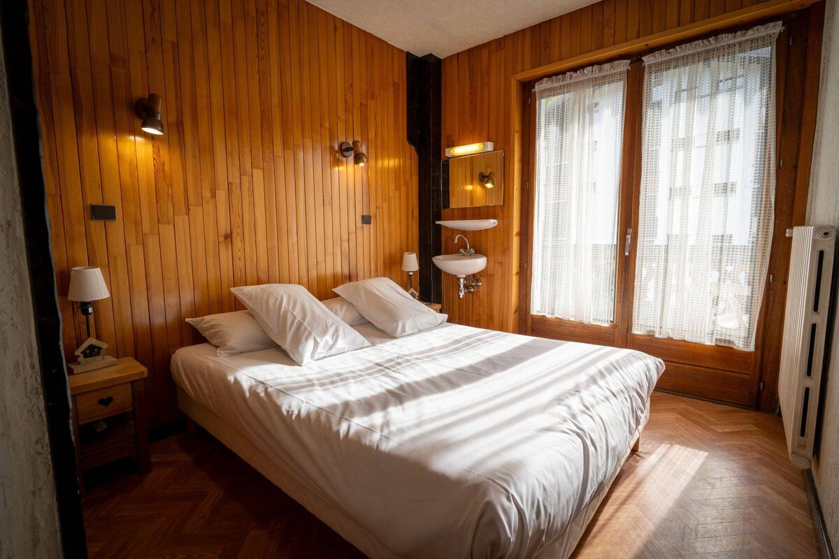 A bedroom with a bed and a sink in it