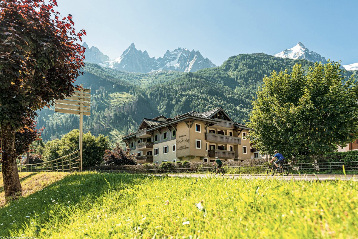 People riding bicycles in front of a building that says