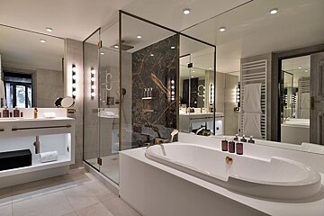 A bathroom with a bathtub a sink and a mirror