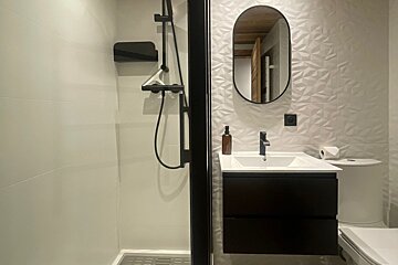 A bathroom with a sink toilet and shower