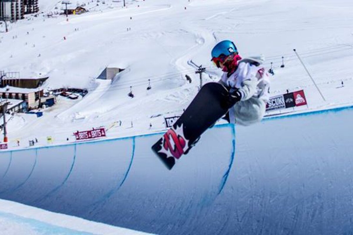 a female snowboarder in the halfpipe