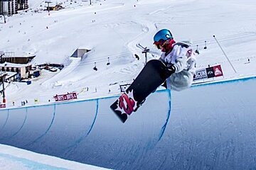 a female snowboarder in the halfpipe