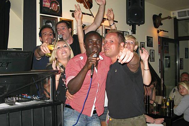 a group of people singing karaoke