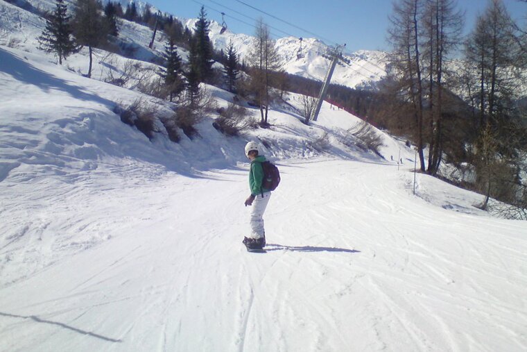 a snowboarder on a piste