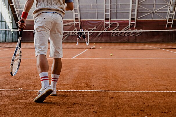 A man holding a tennis racquet on a tennis court