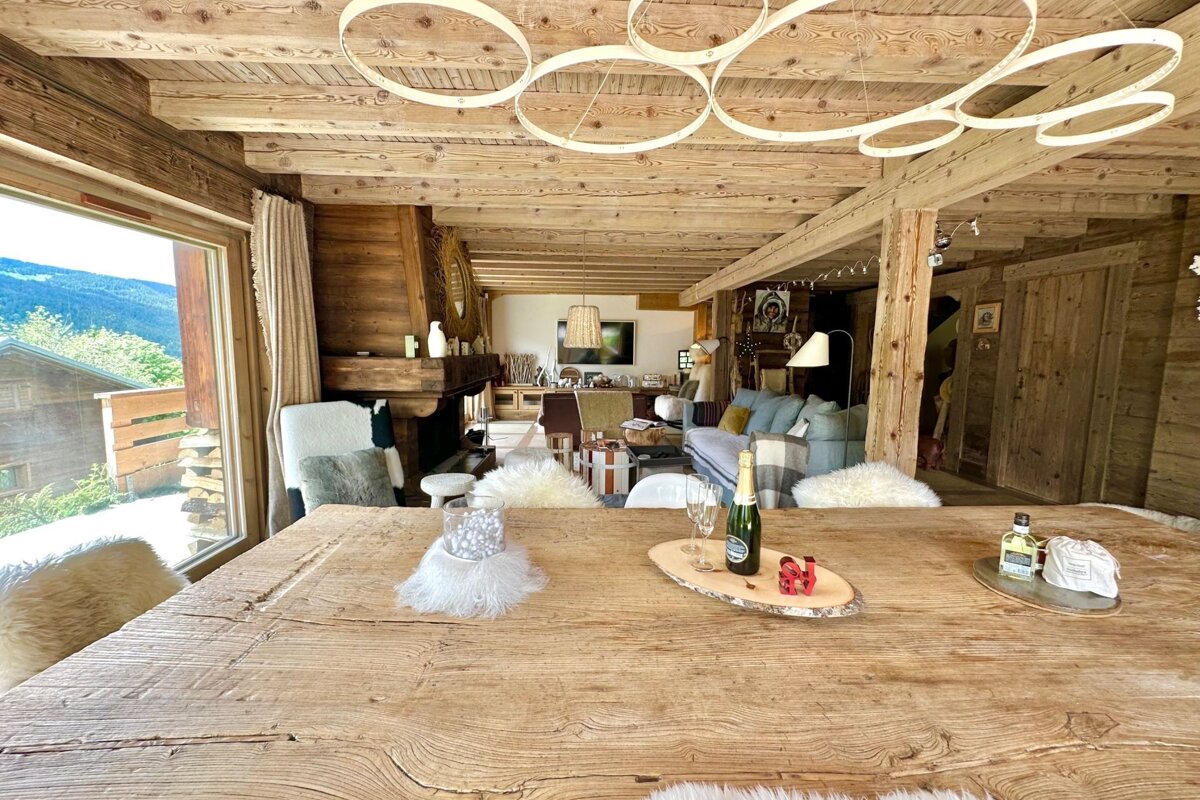 A wooden table with a bottle of champagne on it