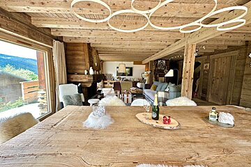 A wooden table with a bottle of champagne on it