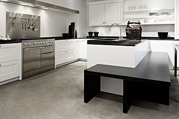 A kitchen with stainless steel appliances and white cabinets