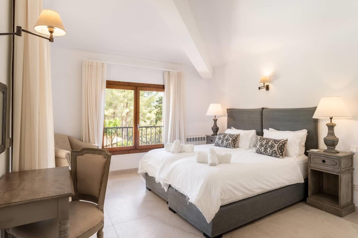 A hotel room with two beds and a chair