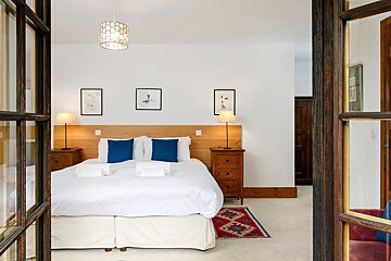 A bedroom with a king size bed and two nightstands