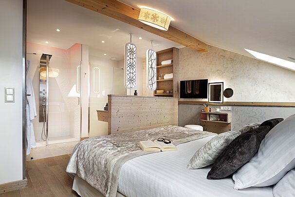 A bedroom with a bed and a book on it