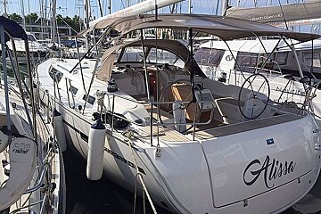 A white sailboat with the name alissa on the back