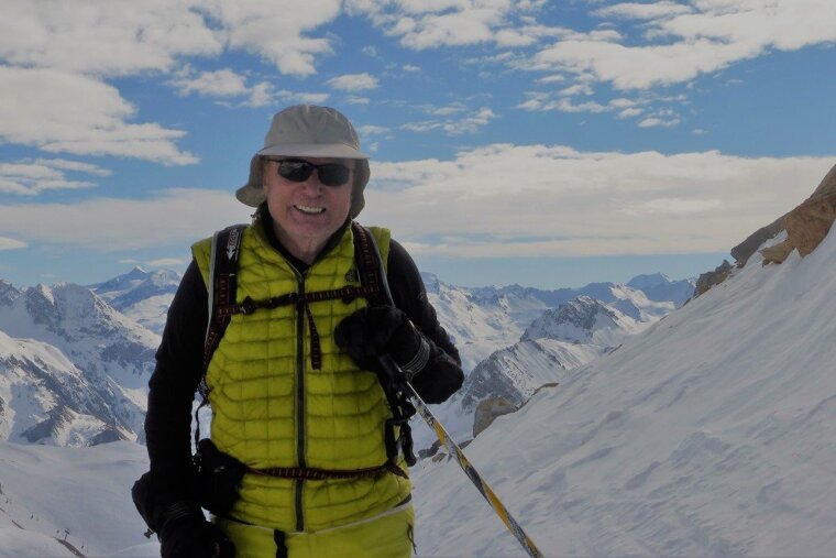 a man smiling in his ski gear