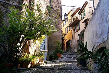 a winding street with stairs in biot