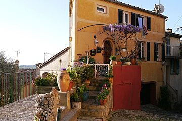 a yellow adn orange house in biot