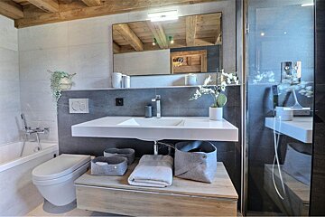 A bathroom with a toilet a sink and a mirror