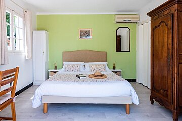 A bedroom with a bed and a hat on it