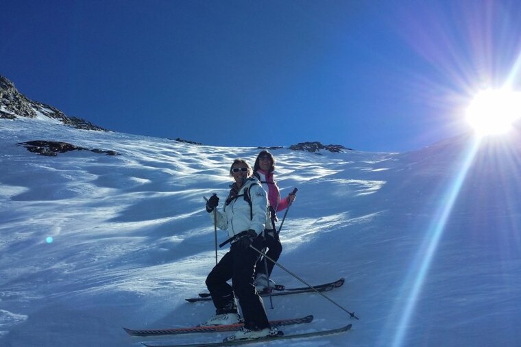 two skiers at the top of a freeride area