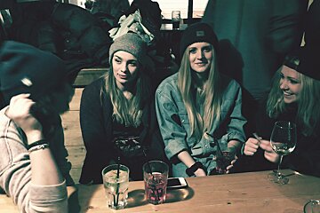 four girls in hats in a bar