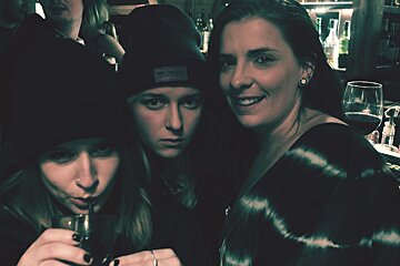 three girls drinking in a bar