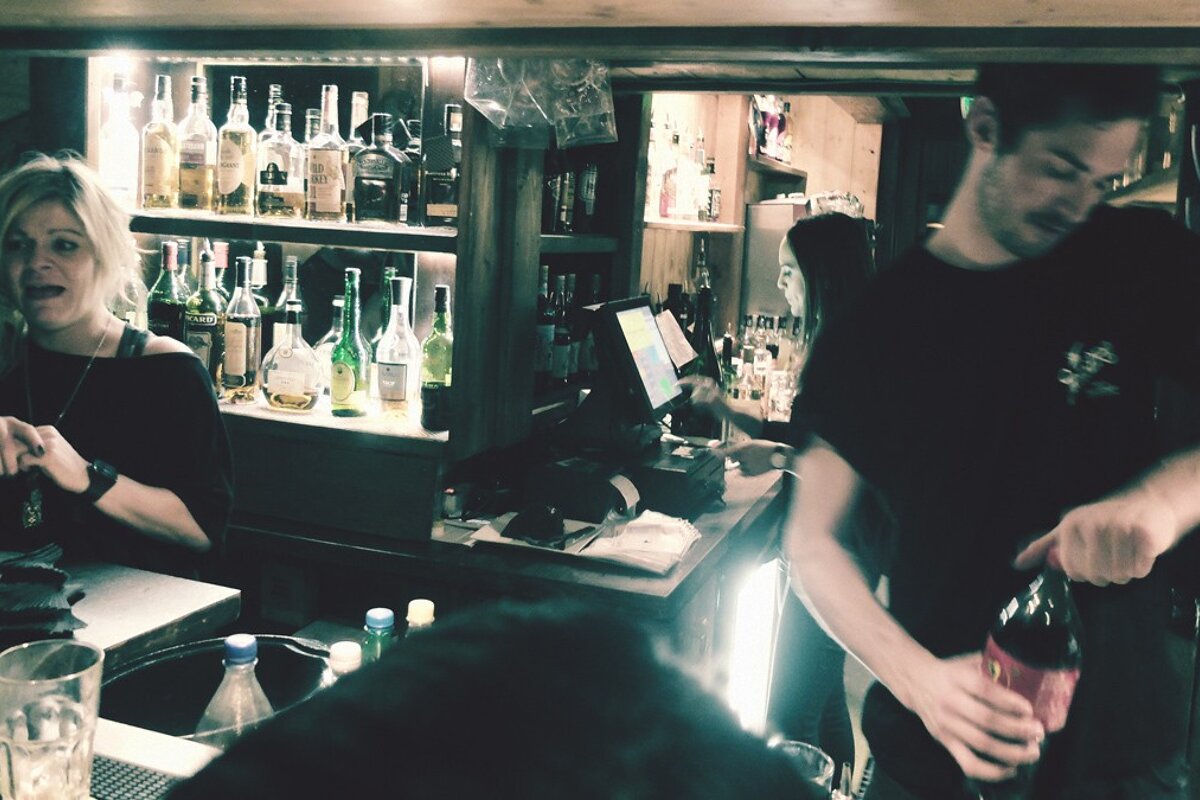 two bar staff working hard in braseros