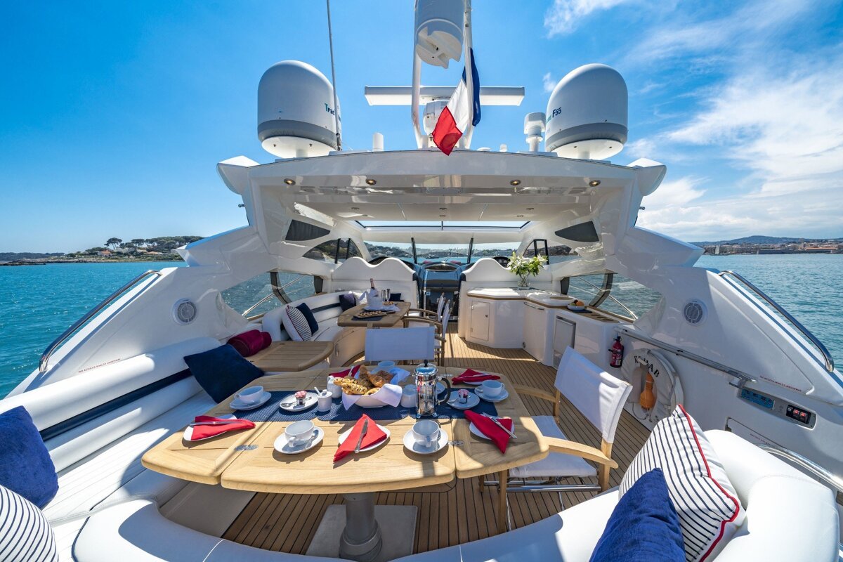 The front of a yacht with a table and chairs set up