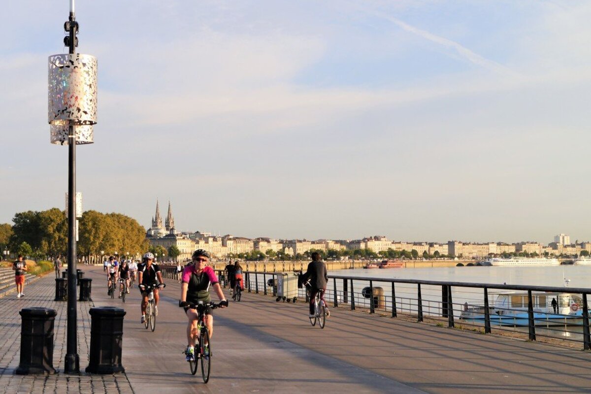 cyclists in the city of bordeaux, waterfront