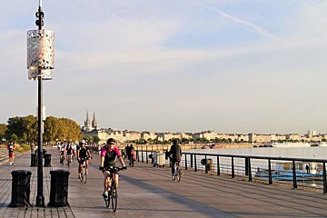 cyclists in the city of bordeaux, waterfront