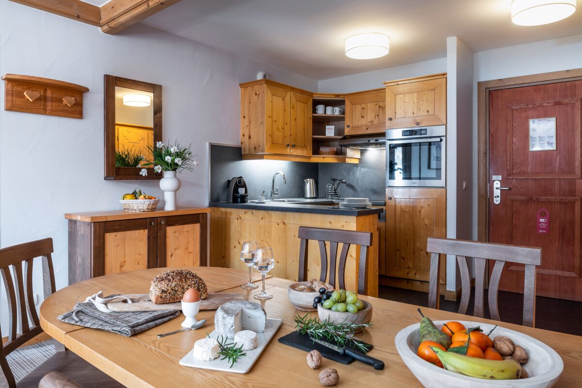 A kitchen with a table and chairs and a door that says ' hotel ' on it