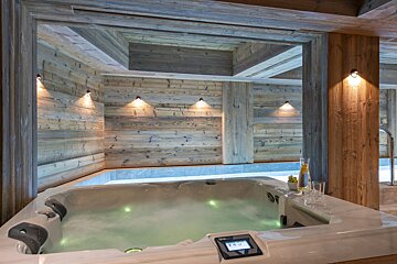 A jacuzzi in a room with wooden walls