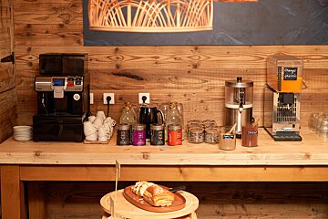 A wooden table with a machine that says orange juice on it