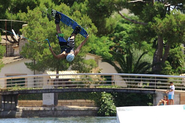 A wakeboarder throwing a trick at Mallorca Wakepark
