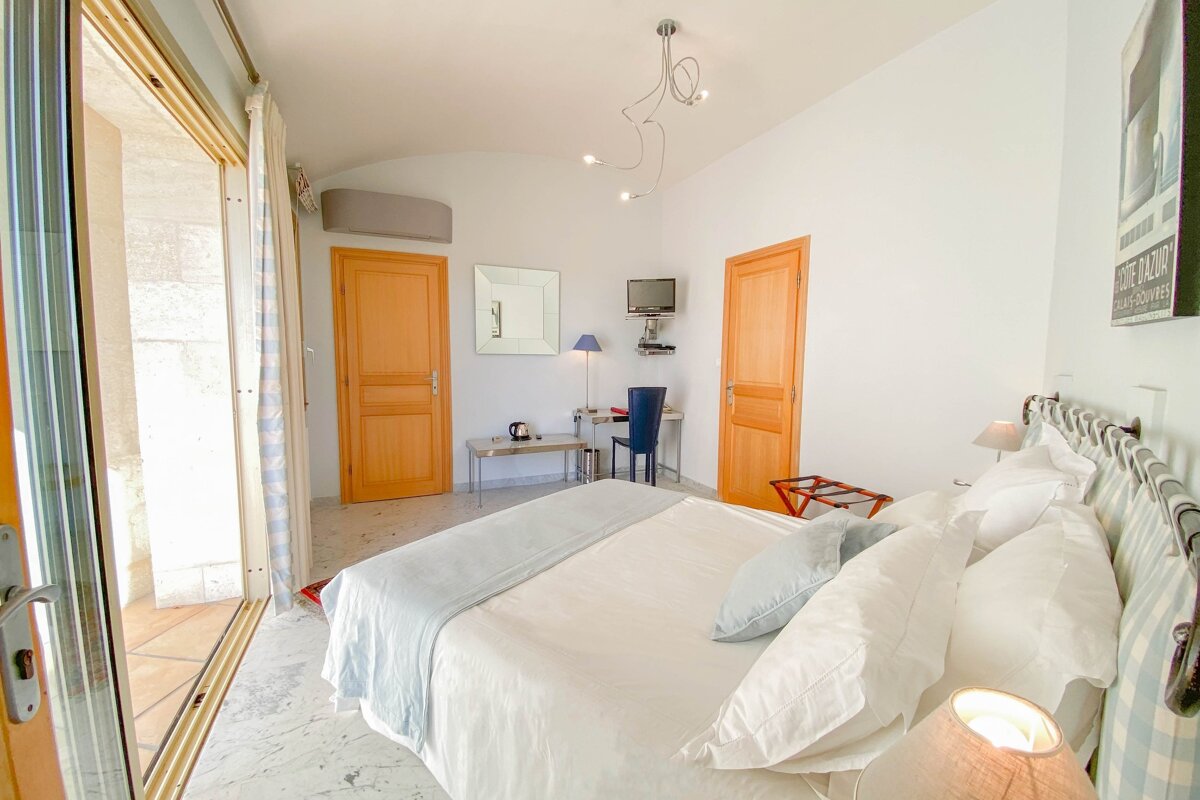 A hotel room with a large bed and a sign that says 