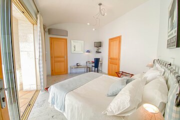 A hotel room with a large bed and a sign that says 