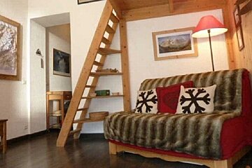 A living room with a couch and a staircase