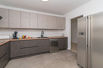 A kitchen with a stainless steel refrigerator and a dishwasher